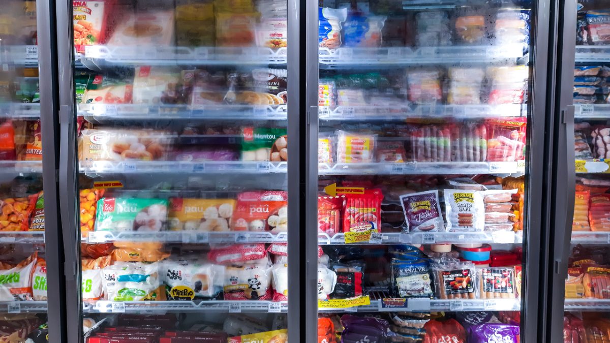 a colorful variety of frozen food in a transparent freezer in a grocery store