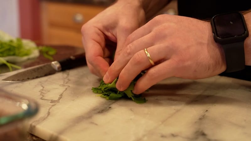 Chopping fresh herbs on a marble cutting board
