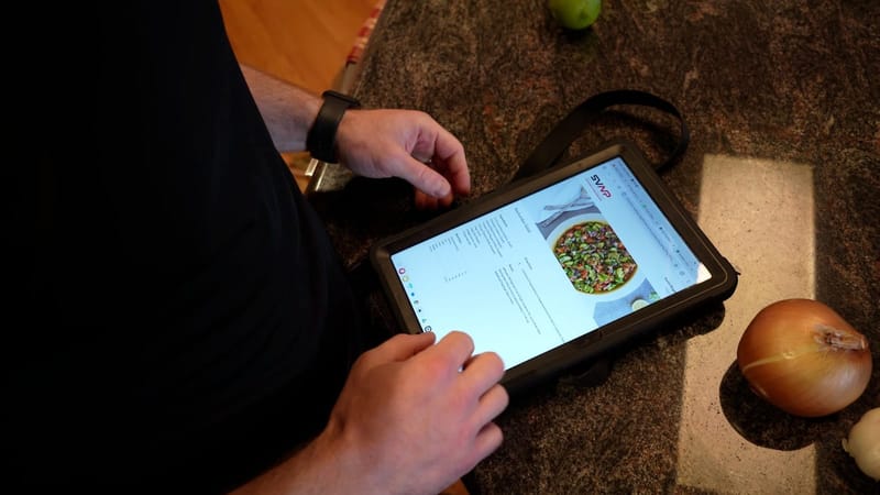 Following a high-protein recipe on a tablet in the kitchen